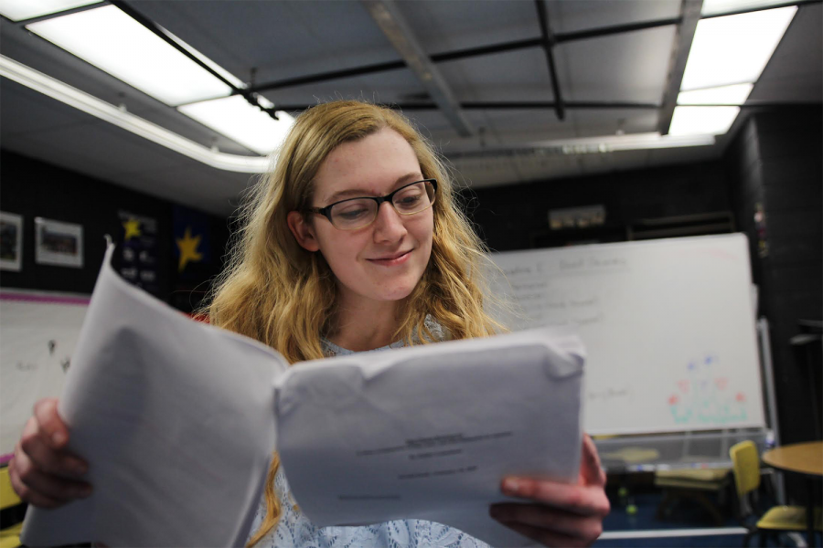 Cassie Hurt-McLarty reads her script for the Social Issues play. 