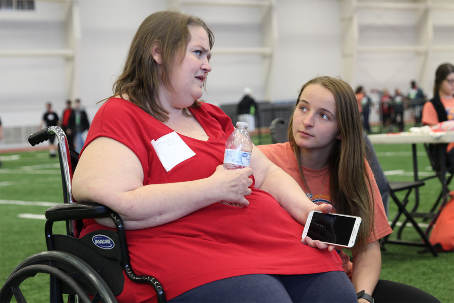 Junior Morgan Noe, a member of the Get Busy Livin (GBL) Club, converses with a Special Olympics athlete before awards. Noe, as well as 18 other members of the club, volunteered at the Special Olympics Track and Field tournament on Thursday, April 18 at the Robert Plaster Centers indoor football field. Ive gotten more experiences with the club, Noe said. Ive gotten to help the community and give back, which is what GBL is all about.  