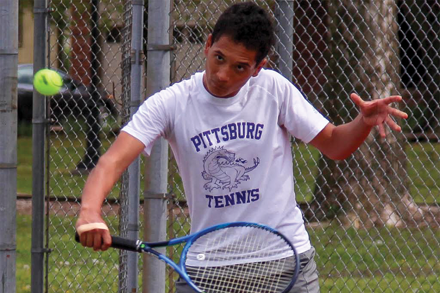 Junior Devin McAfee slices the ball back to his opponent. McAfee has been playing tennis since he was young, and this is his third time competing at the State Tennis Tournament.