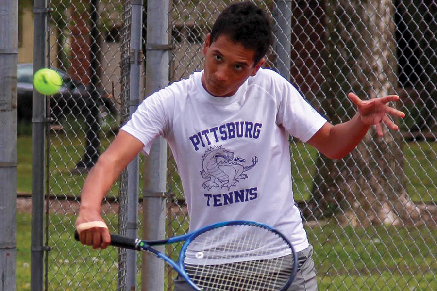 Junior+Devin+McAfee+slices+the+ball+back+to+his+opponent.+McAfee+has+been+playing+tennis+since+he+was+young%2C+and+this+is+his+third+time+competing+at+the+State+Tennis+Tournament.