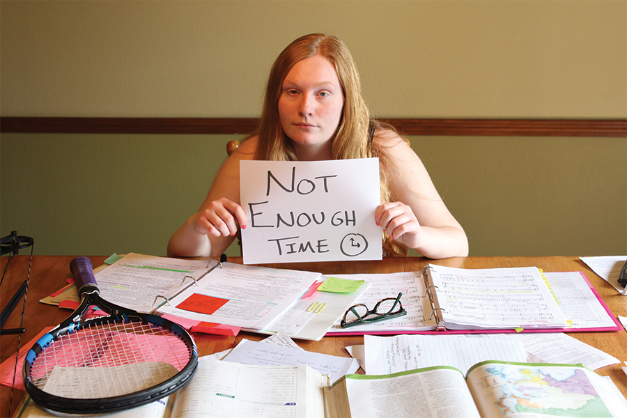 Freshman Emma Fischer scrambles to finish her homework before the clock strikes midnight.