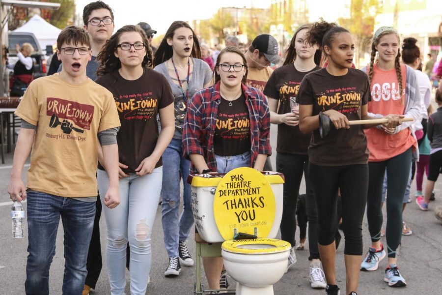 Cast members from Urinetown walk at the Pittsburg Art Walk on Friday, April 20 singing along to the soundtrack, collecting donations. 