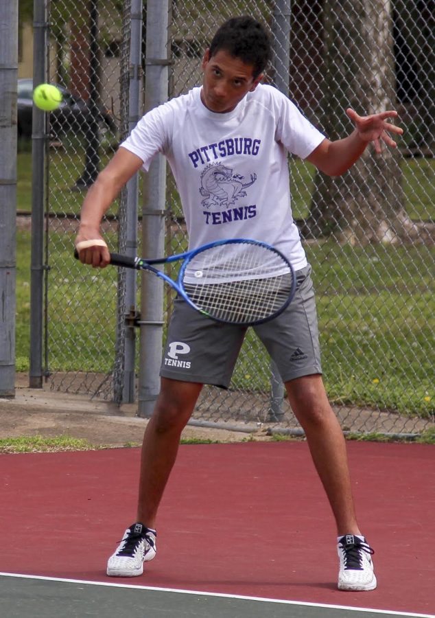 Junior Devin McAfee slices the ball back to his opponent. McAfee has been playing tennis since he was young, and this is his third time competing in the State Tennis Tournament. 