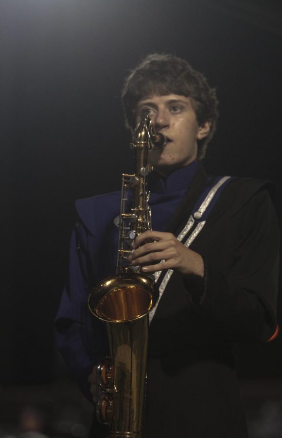 Senior Andrew Riachi plays the saxophone at a home football game. Riachi, whos also involved in vocal music, Technology Student Association and First Robotics, was named a National Merit Scholarship semifinalist this month. 