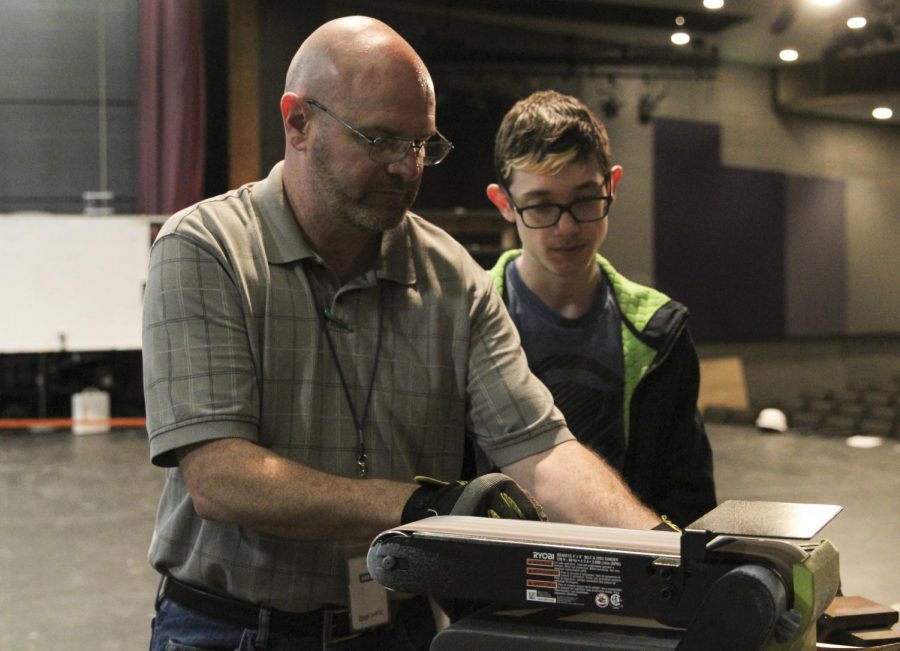 Chuck Boyles helps sophomore Cole Ingerson create a prop as a class project. While this is Boyles first year teaching a class, he has been helping behind the stage at PHS for four years.