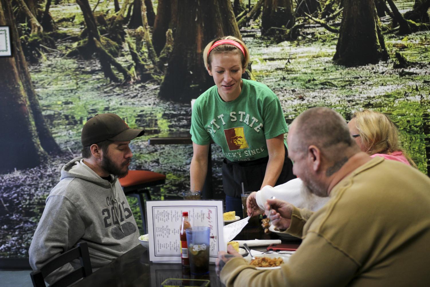 A server at Mandy's Place sets down a plate to a group of customers dining during its grand opening. Mandy's place is owned by Mandy Duncan and Opened Oct. 20 and features Southern cooking. ''If it's not on my menu, I'll cook it for you if I have to,