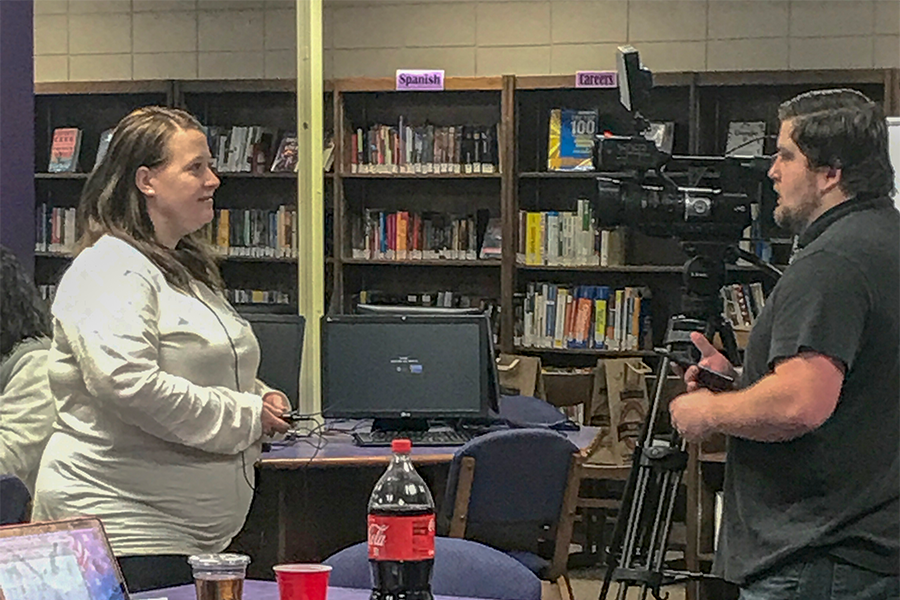 Head debate and forensics coach Julie Laflen responds to interview questions from a local television station at the teams annual home tournament. This years student-run tournament was the largest in school history, with over 300 competitors from 21 different schools. 