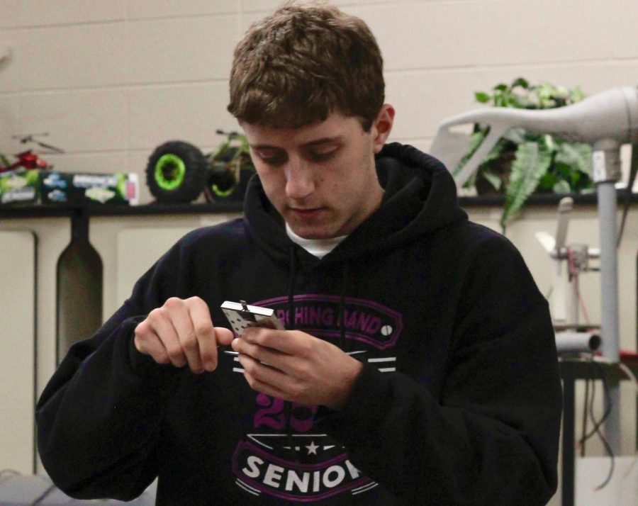 Senior Andrew Riachi, programmer for the FIRST robotics team, puts the final touches onto one of the parts of his teams robot. Once completed, the team competed at the Greater Kansas City Regional Competition, and placed 28th out of 36 teams. 