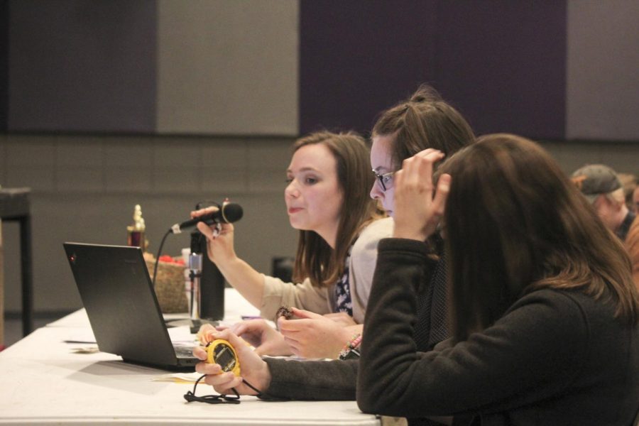 During the Book Clubs first school-wide spelling bee, English teacher Emily Rountree, who is also the sponsor of the club, announces the next word for the contestant. Juniors Kylee Eidson (left) and Mikayla Kitchen — club officers — time the spelling and read along with the word. 