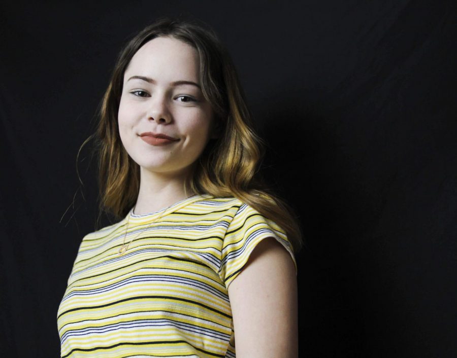 Culbertson shows off her thrifted yellow and gray striped t-shirt. Photo by McKenna Hodges