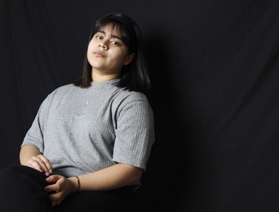 Garcia poses in her gray sweater that she bought second-hand. Photo by Cassidy Bayliss