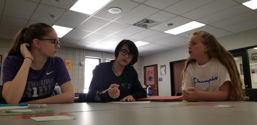 Experienced debater sophomore Rylee Scott works with two novices on their practice debate round.