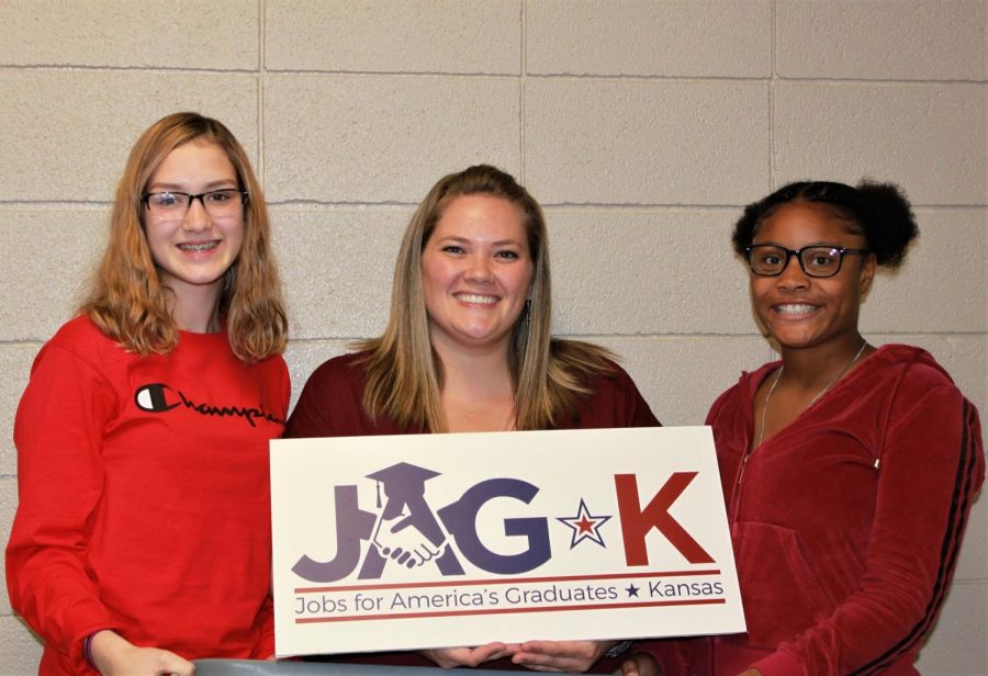 Adelina Tice, JAG teacher Jessica Thomas and I'sis Thomas stand with the new JAG sign.