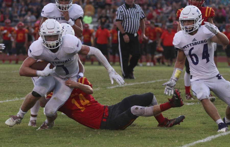 Senior Sam Roark breaks the tackle against Labette County on Sept. 6, 2019.