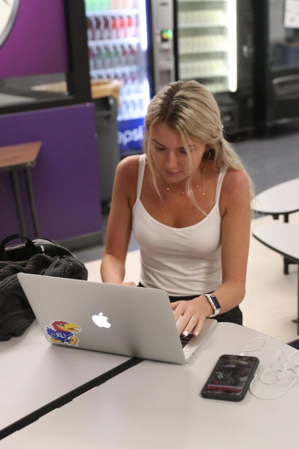 Senior Keirstin Dunsworth completes work for an online class in the commons area during her free hour wearing a cami tank top. 