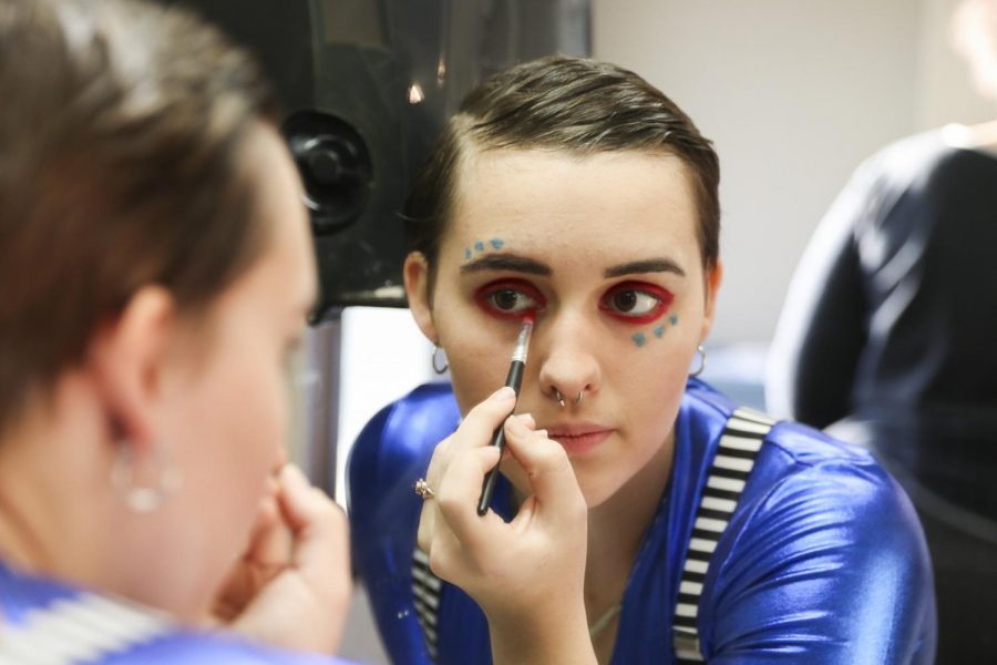 Junior Tabor Workman and other cast members of Pippin apply their makeup as they get ready for the show. 