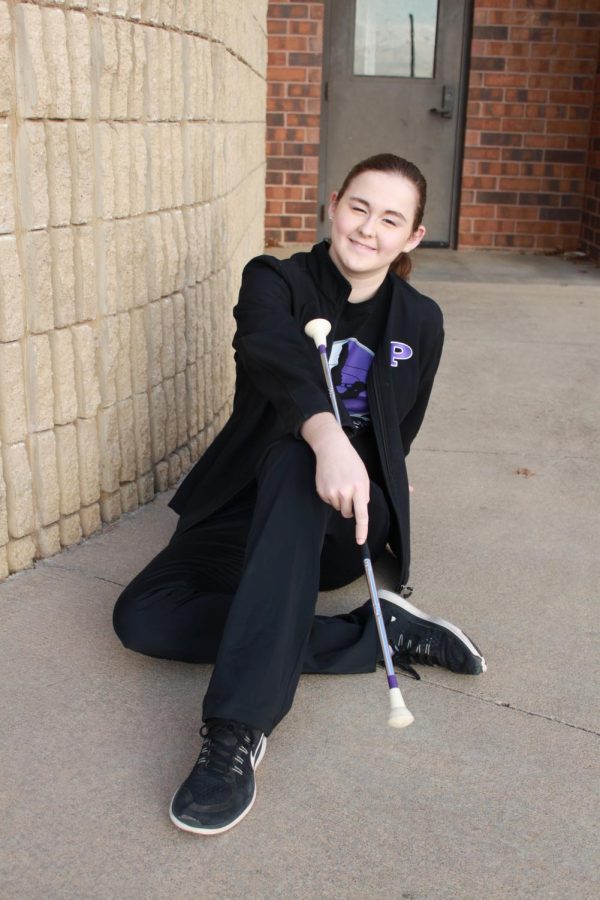 Posing with her baton, freshman Ashleigh Henderson twirls with the band and recently helped actors prepare for a performance of Pippin.