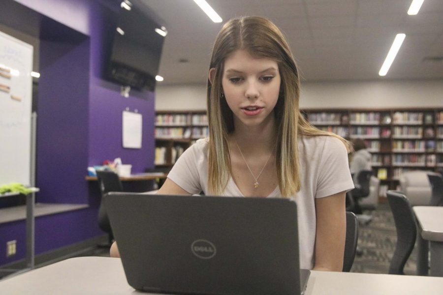 Sarah+Stebbins+works+in+the+library+while+taking+her+online+class.