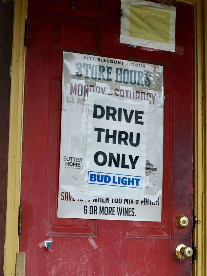 Photo credit: Ashlan Brooks.
Sign posted on the outside of Pitt Discount Liquors main entrance. Sign advertises that people use their drive through only due to the Coronavirus pandemic.