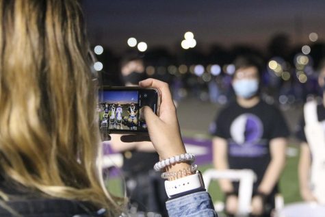 Senior drummers Xavier Huffman (12), Declan Ortiz (12), Josh Ortolani (12), Rebekah Sheward (12), and Christopher Saman (12) get their picture taken after the halftime show by Sarah Stebbins (12).