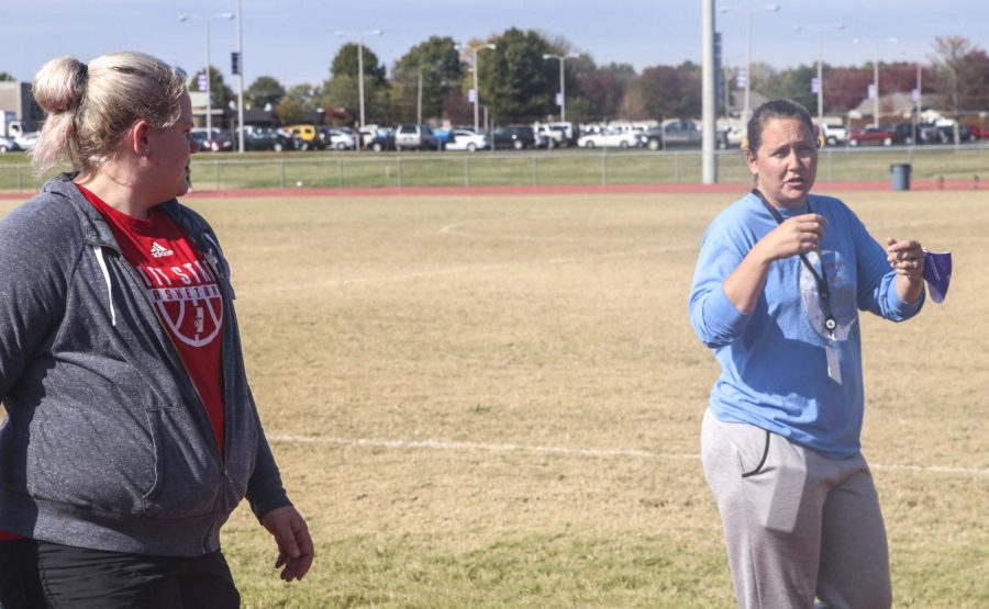 Bridgett Lancaster and powerwalking student Ella Henrickson walk side-by-side.