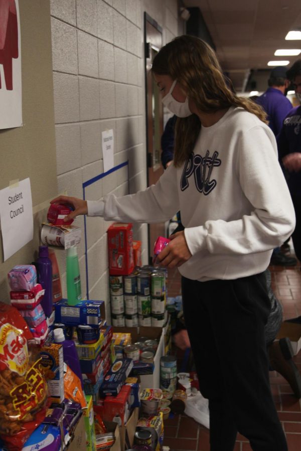 Junior Abby Painter stacks hygiene products.