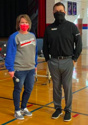 Chet Kuplen poses in high school gymnasium while working for Sports in Kansas.