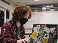 Senior Elliot Norman prepares to debate virtually in Laflens debate classroom.