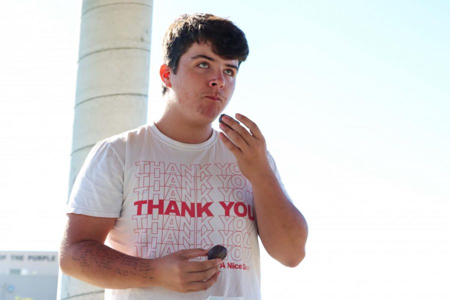 Photo Caption: Senior Dakota Reese focuses on eating his donuts during the donut eating competition. “​​I wouldn’t recommend watered down donuts to anyone.” Reese said.