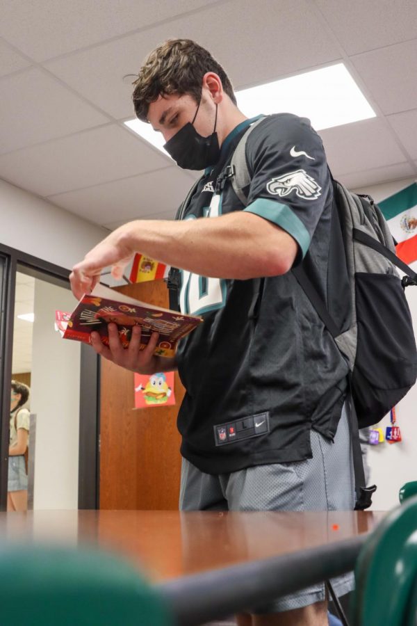 Senior Andrew O'Doherty reads a book chosen by Book Club.