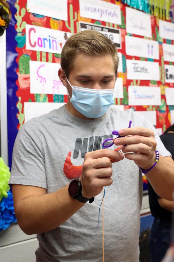 Senior Jourdain Granere makes a Guatemalan worry doll.