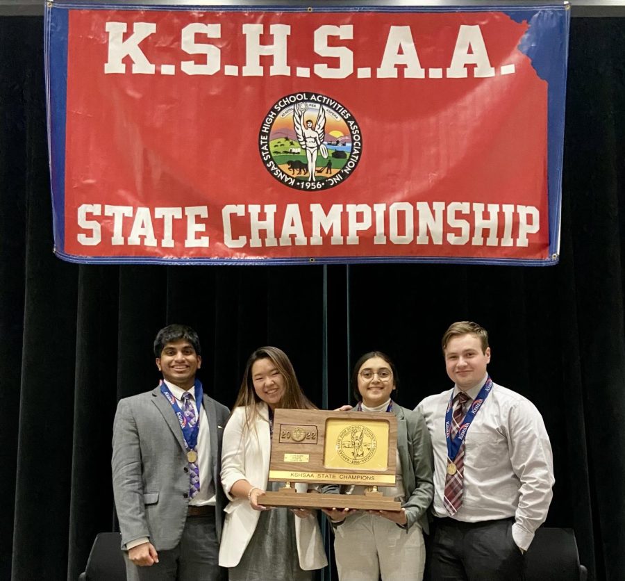 Seniors+Jacob+Mathew%2C+Joy+Lee%2C+Katie+Rodriguez+and+Owen+Miller+pose+with+their+champion+plaque.