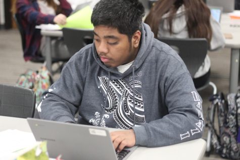 Junior Solomon Anien is working on a worksheet in Julie Laflen's speech class
