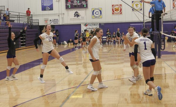 Hailey Gray, Erin OConnell, Heather Mowdy, Rileigh Manuel, and Ivery Watts celebrate after earning a point during jamboree game versus Fort Scott. 