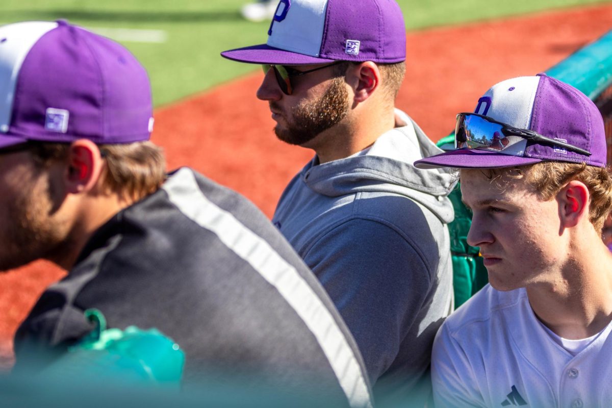 Coaches Noah Vaughn, Dalton Gromer, and sophomore Cole Hayden watch the Pittsburg batter.
