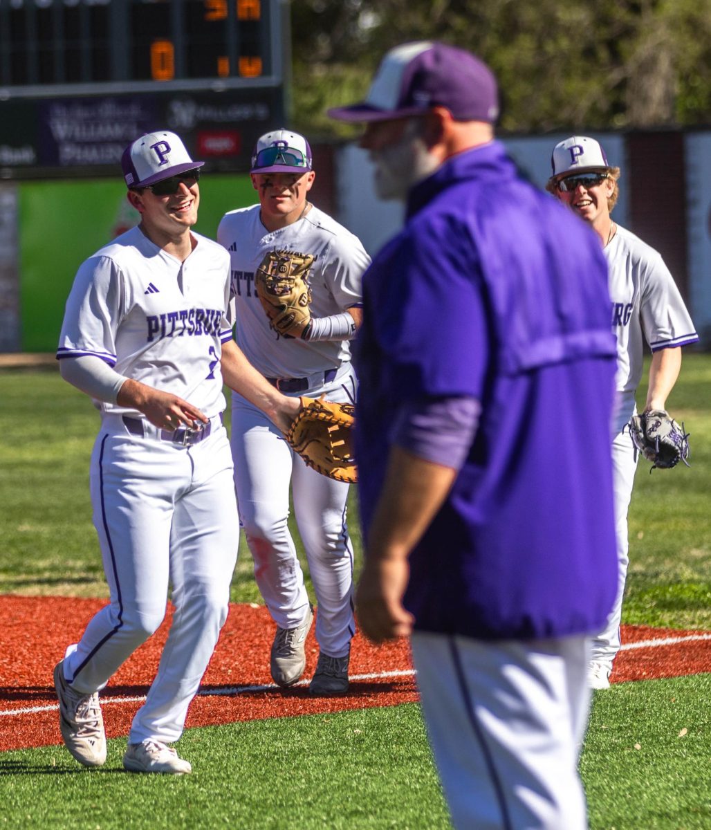 Seniors Grant ODoherty, Tucker Akins, and Parker Johnston run back to the dugout to have a team discussion with Head Coach Eric Miller after a throw to first to get the third out of the inning.