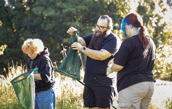 Natures finest catch, Ecology teacher Steven Seeley helps his Junior student Addilyn Miller put a bug in the jar, while Junior Jayden Jarvis looks in her net to see if she caught something. 