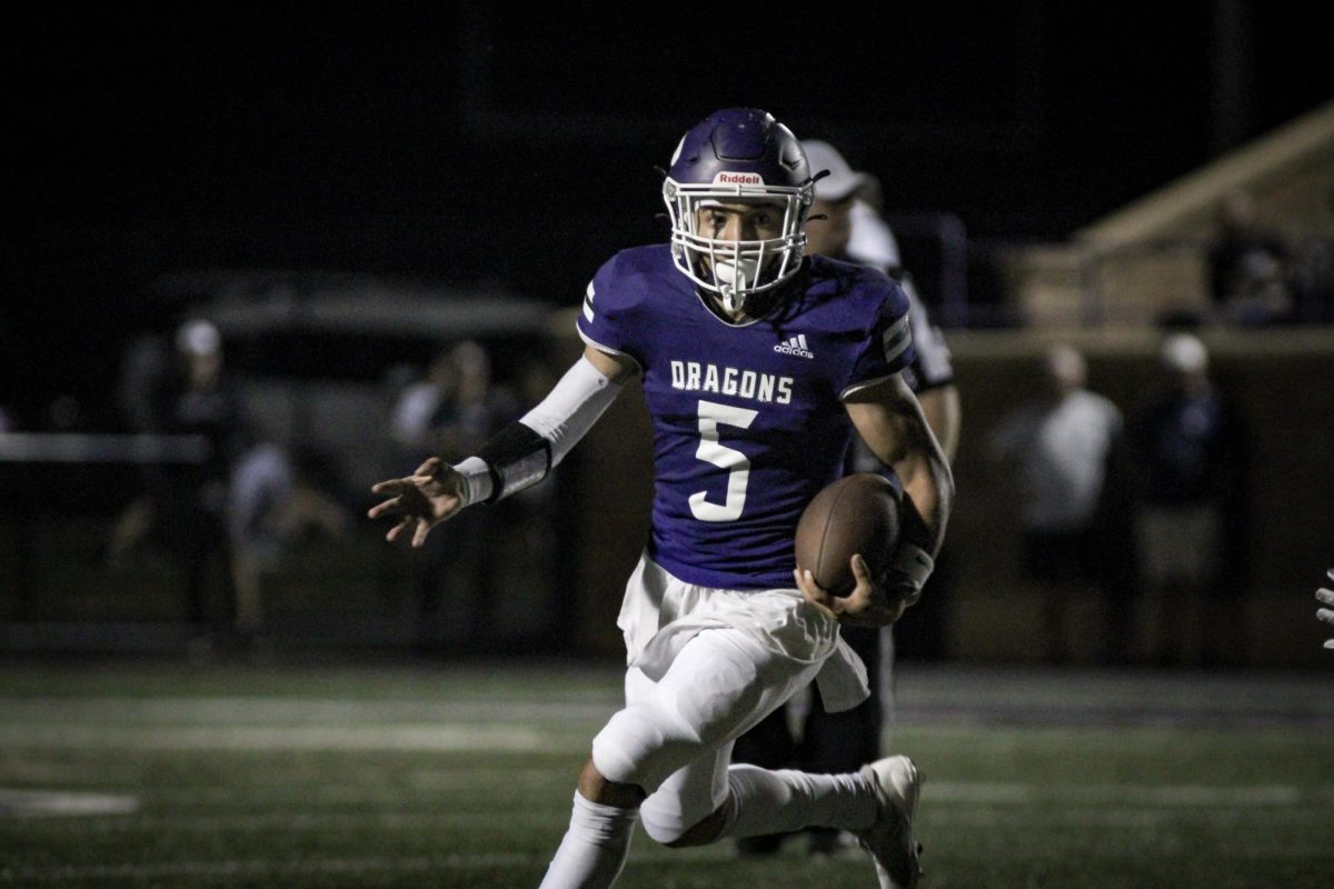 Junior Jamarcus Davis rushes towards the endzone whilst avoiding Paola's football team at Hutchinson Field on Oct. 3 2025.