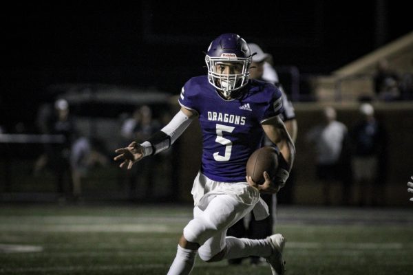 Junior Jamarcus Davis rushes towards the endzone whilst avoiding Paola's football team at Hutchinson Field on Oct. 3 2025.